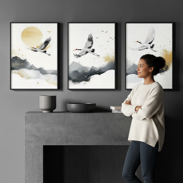 How to use wall art to brighten a dark room — woman admiring crane art set of 3 above fireplace in dark moody interior