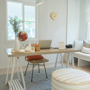 Bright Scandinavian home office with trestle desk, globe, and minimal wall decor ideas