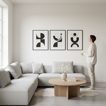 Bright minimalistic living room with black and white framed art prints