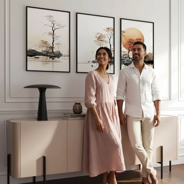 Mixed-race couple standing beside Asian inspired wall art prints in a beautifully styled sustainable living room, showing how to incorporate sustainable materials in interior design