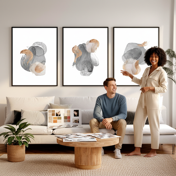 Interior designer budget planning — designer discussing wall art choices with client in a bright Scandinavian living room