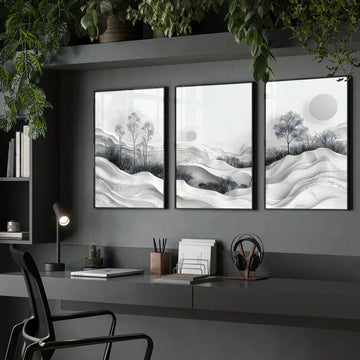 Three framed black and white wall art prints creating a calming wall above a modern dark grey desk