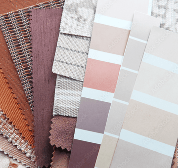 Fabric swatches and paint colour samples in warm terracotta and taupe tones for bedroom colour schemes
