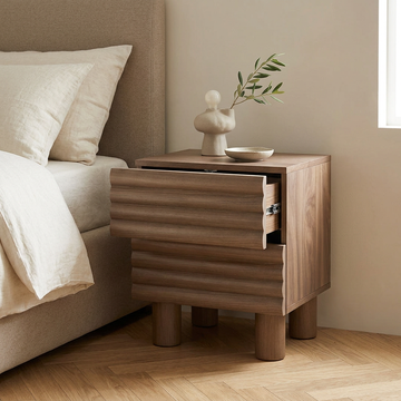 11. Clancy wooden bedside table with an open drawer in a beige bedroom