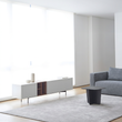 12. Acacia white TV stand beside a grey sofa