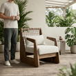 13. Delaney armchair with a person standing beside it on a covered garden terrace