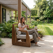 14. Delaney armchair with a person enjoying coffee on a sheltered garden patio