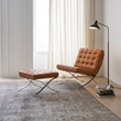 2. Barcelona brown leather chair and footstool beside a window
