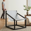 2. Kendari light grey leather sling chair in an ivory living room with a person in the background
