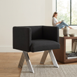 2. Piermount black chair in an ivory living room with a person in the background