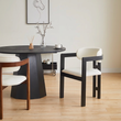 2. Sara black dining chair beside a round table