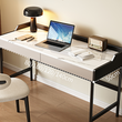 Modern desk with laptop, lamp, and chair in a room setting