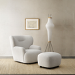 3. Carmen armchair and footstool beside a floor lamp