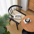 3. Eenoch black dining chair with an open magazine