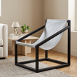 3. Kendari light grey leather sling chair beside a travertine table in a beige living room