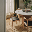 3. Kennedy light oak dining chair beside a window