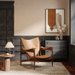3. Zelenko tan leather lounge chair beside a chest of drawers