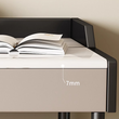 Beige desk with black frame holding an open book, showing a 7mm thickness measurement.