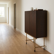 4. Delta walnut drinks cabinet against a light ivory wall with a clear hallway passage