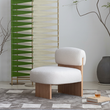 4. Evander white boucle chair beside a woven screen