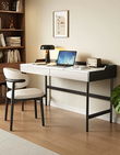 Modern home office with a white desk, black chair, and laptop.