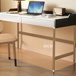 Modern desk with laptop, lamp, and radio in a home office setting.