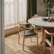 6. Kennedy light oak dining chair beside a window