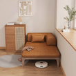 6. Ocampo brown leather sofa bed with a robot vacuum underneath