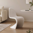 7. Aimee white dining chair side profile beside a sofa