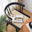 7. Eenoch black dining chair seat detail with a magazine