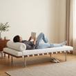8. Barcelona white leather daybed with a person reclining and reading