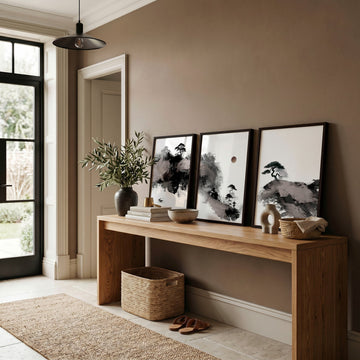 Calming Wall Art Japanese Ink Landscape with Maroon Sun, Black Pine Trees & Lone Fisherman displayed on a wall in a styled room