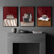 Canvas Wall Art Sets of 3 Burgundy Book Lover Reading Nook wall art displayed on a wall in a styled room