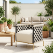 Satna black and white jute rope woven chair on a bright garden patio in a wide view