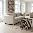 Safira black and white stripe leather pouffe in a wide Scandinavian living room view