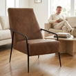 Hoxton brown leather lounge chair in a bright living room with a person in the background