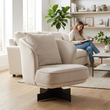 Hale cream velvet swivel chair with cushion in a bright living room with a person in the background