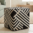 Safira black and white stripe leather pouffe viewed from above at an angle in a contemporary living room