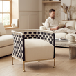 Satna black and white jute rope woven chair in a bright living room with a person in the background