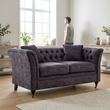 Sabrina grey velvet sofa in a bright living room with a person in the background