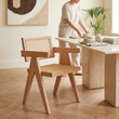 Cebu natural cane dining chair in a bright dining room with a person in the background