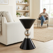 Jaipur black and silver finish hourglass side table in a bright living room with a person in the background