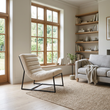 Vogue ivory velvet channel tufting lounge chair in a wide Scandinavian living room view