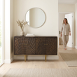 Sipari dark mango wood carved sideboard in a bright hallway with a person in the background