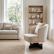 Hale cream velvet swivel chair with cushion in a wide Scandinavian living room view