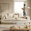 Avignon cream fabric three seater sofa in a bright living room with a person in the background