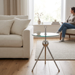 Oria clear glass and silver side table in a living room with a person in the background