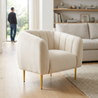 Yasmeen ivory velvet channel tufted armchair in a bright living room with a person in the background