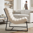 Vogue ivory velvet channel tufting lounge chair in a bright living room with a person in the background